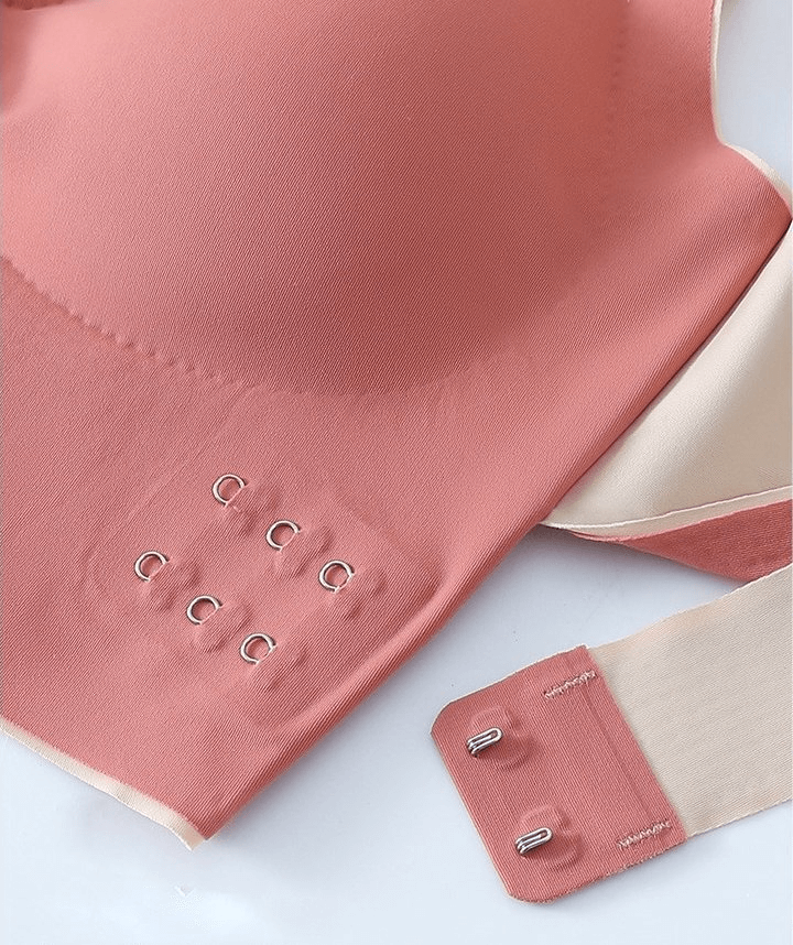 Stylish pink sports bra with elastic cross back, front closure, and shockproof push-up support for women. Model SF0483.